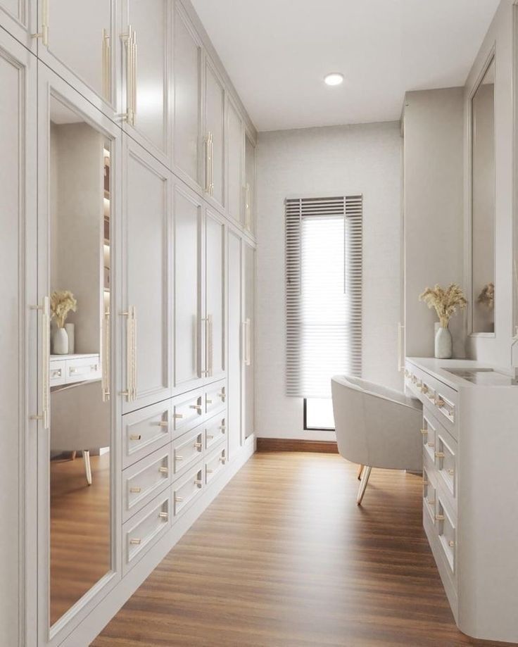 a large white closet with lots of drawers