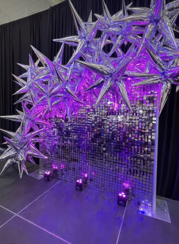 an artistic display with purple lights and stars