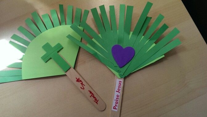 a paper fan with a purple heart on it and a green stick sticking out of it