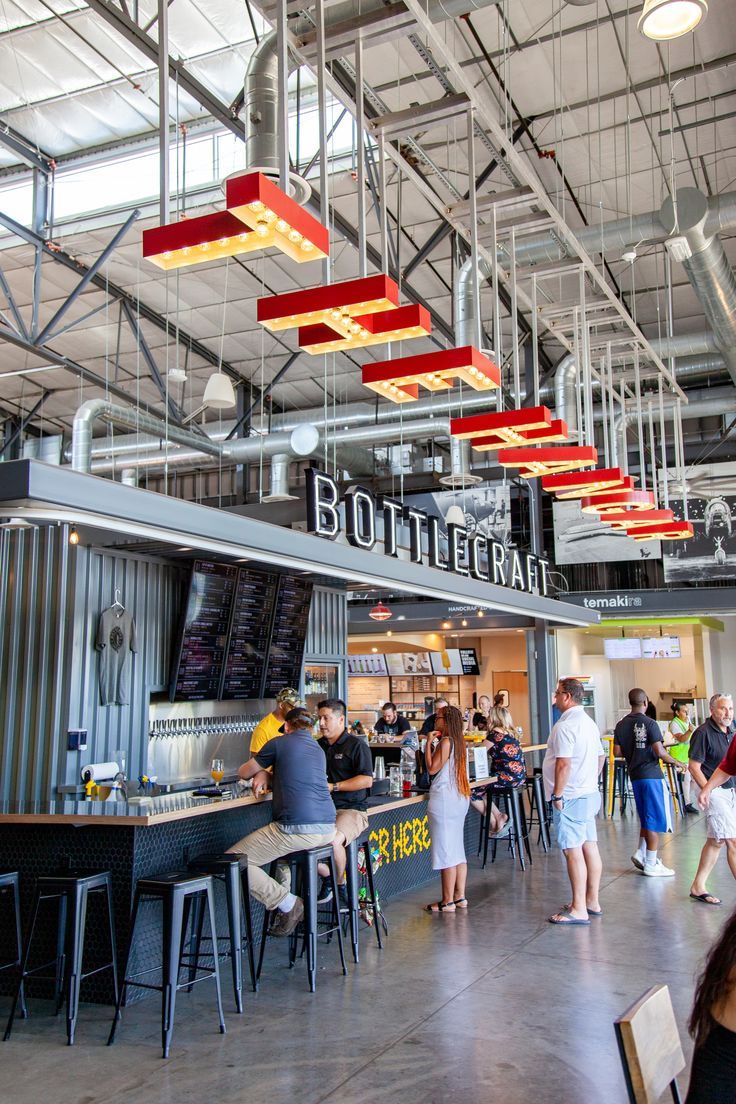 the inside of a restaurant with people eating and drinking