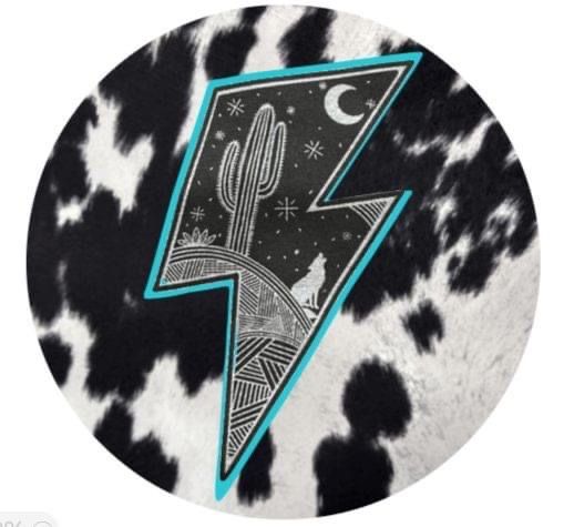 a black and white cow print with a blue lightning bolt on it's side