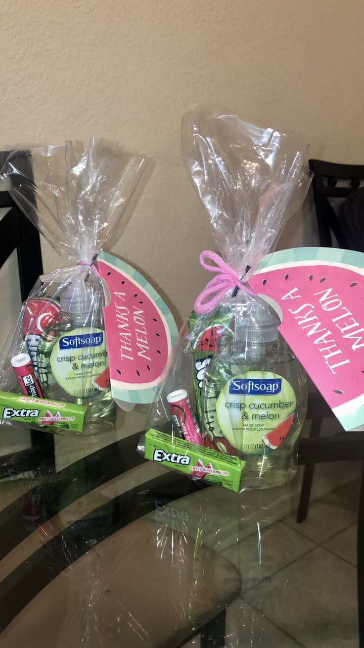 two watermelon slices wrapped in plastic and sitting on a table next to each other