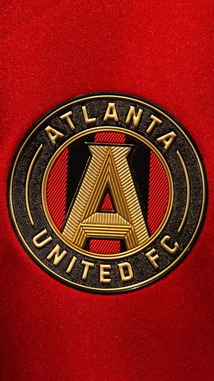 the atlanta united soccer team emblem on a red jersey shirt with black and gold letters