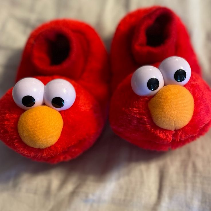 a pair of red slippers with googly eyes