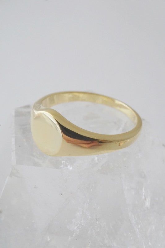 A miniature, sweet signet ring in a slim band with a flat, blank top. Our materials make for an amazing, high quality, seamless, jewelry piece with longevity. Our rings are plated with 24k gold, 18k rose gold, or sterling silver and finished with a protective coating. A little secret we'll keep between us: it looks way more than it costs. Minimalist Hallmarked Dome Ring For Everyday, Polished Rounded Promise Ring Jewelry, Simple 14k Gold Jewelry With Smooth Bezel, Everyday Yellow Gold Sterling Silver Signet Ring, Minimalist Hallmarked Dome Ring With Round Band, Gold Polished Signet Ring, Gold Polished Finish Signet Ring, Gold Polished Finish Rounded Signet Ring, Rose Gold Jewelry With Smooth Bezel As A Gift