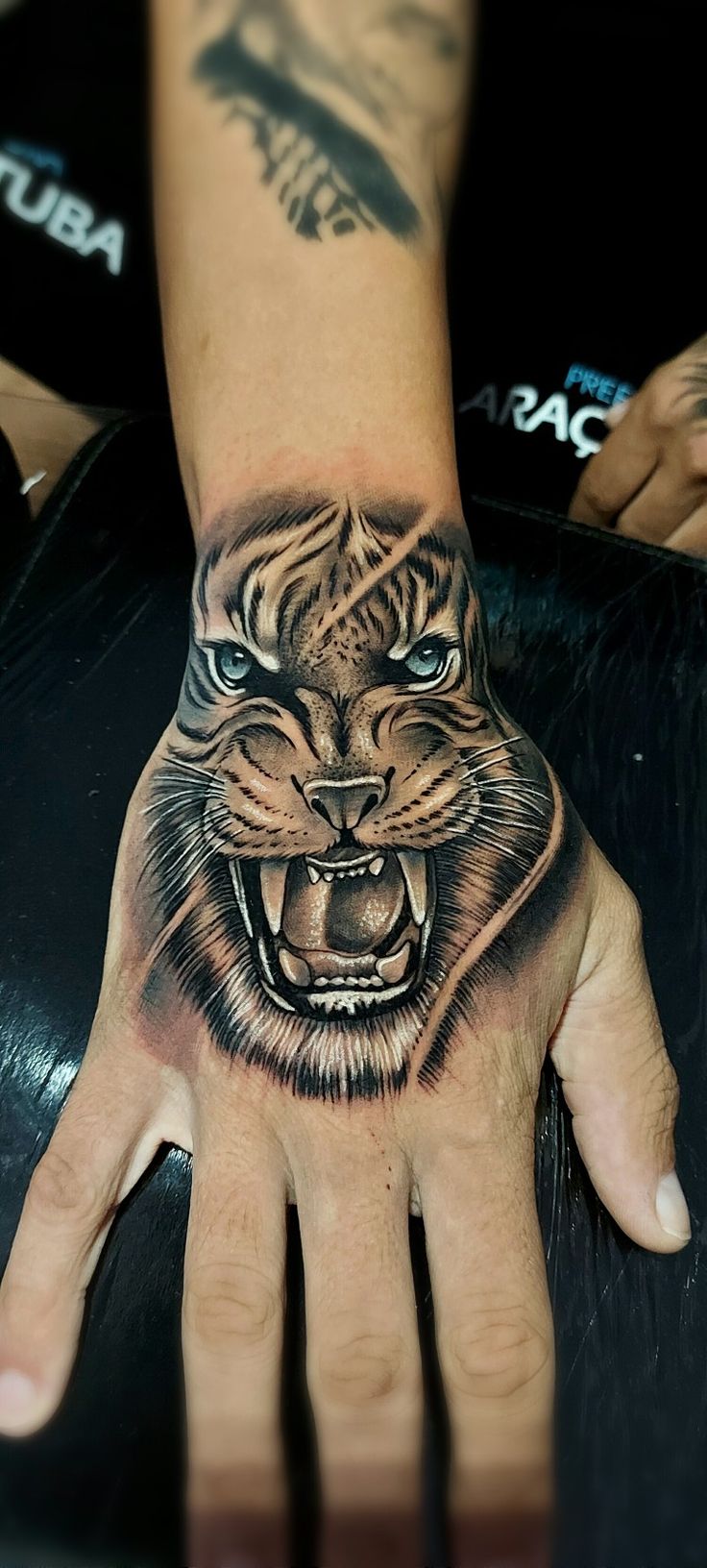 a hand with a tiger tattoo on it