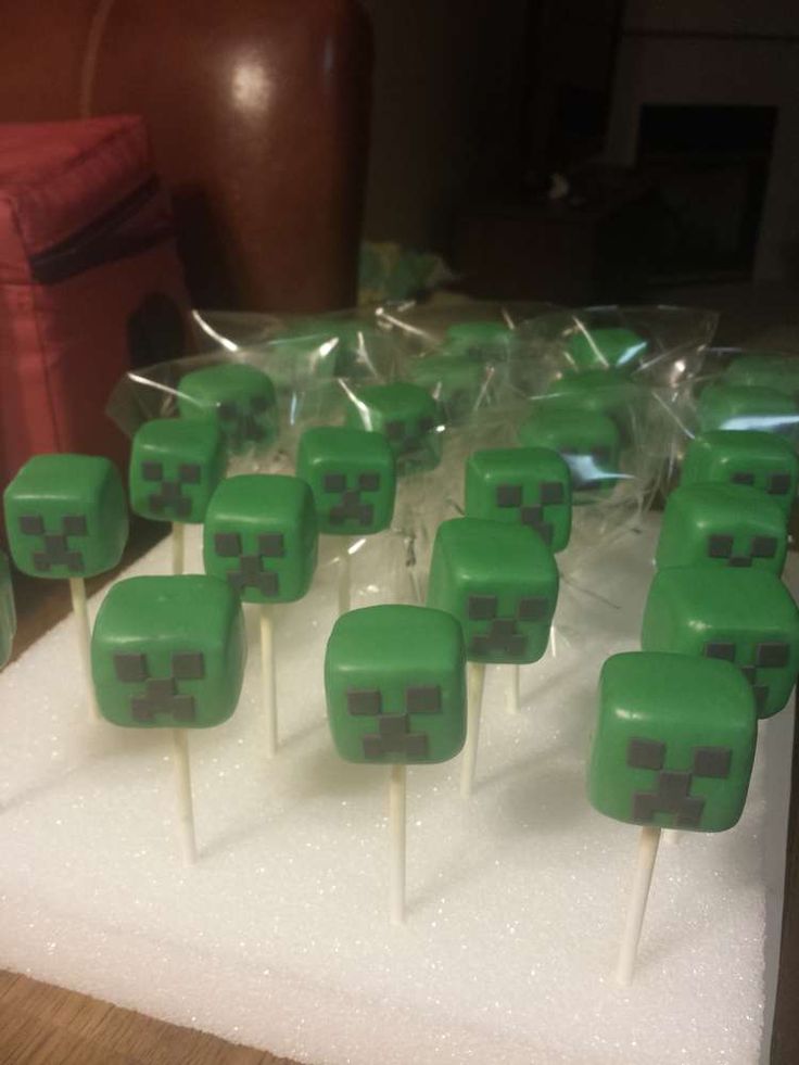 there are many green cake pops on the table