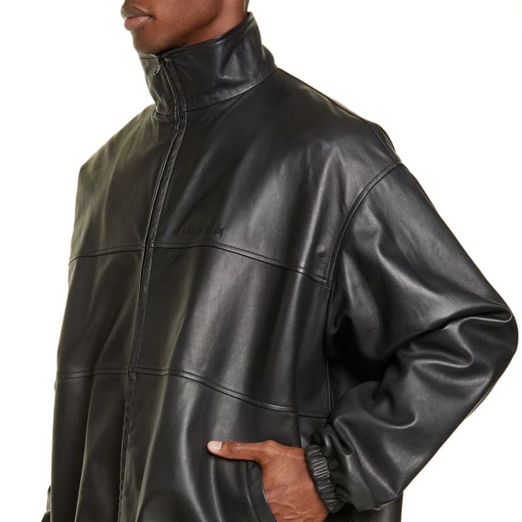 Balenciaga Doesn't Do Anything By Half Measures, It's Always Oversized. This Black Lambskin Panelled Bomber Jacket Is A Prime Example And Its Silhouette Can Be Manipulated With The Drawstring Hem And A Belt Around The Waist. Featuring A Stand-Up Collar, A Front Zip Fastening, An Embroidered Logo To The Front, Long Sleeves, Elasticated Cuffs And A Drawstring Hem. Luxury Spring Outerwear For Streetwear, Luxury Spring Streetwear Outerwear, Designer Oversized Black Outerwear, Designer Black Oversized Outerwear, Black Designer Oversized Outerwear, Designer Leather Jacket For Spring Streetwear, Balenciaga Jacket, Balenciaga Men, Painting Leather