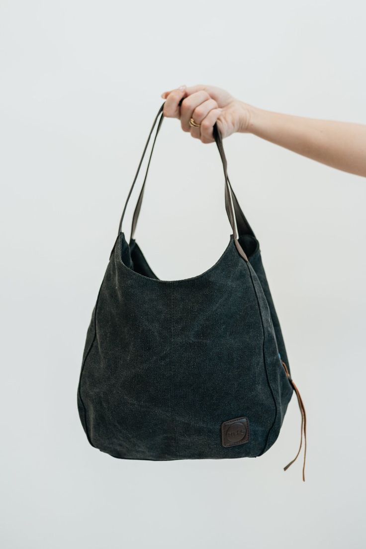 our anniston hobo bag is as cute as it is functional. the slouchy look pairs perfectly with some amazing qualities to help you store and easily access all of your daily essentials. it comes with two magnetic-snap compartments on top of each side of the main zipper-enclosed compartment. this makes it a breeze to throw in your phone or keys that you might need quick and easy access to, while still being able to zip up your wallet or cash in a more concealed and safe compartment. you're going to lo Hobo Bag With Zipper Pocket, Versatile Green Hobo Bag, Green Large Capacity Hobo Bag For Everyday, Everyday Large Capacity Green Hobo Bag, Green Hobo Bag For Everyday Use, Versatile Green Hobo Bag For Daily Use, Trendy Green Hobo Bag With Zipper Pocket, On-the-go Hobo Bag With Zipper Pocket, Green Double Handle Hobo Bag For Everyday Use