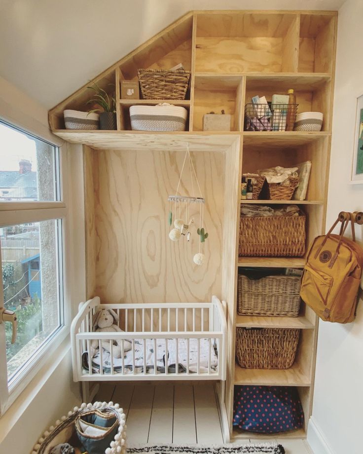 a baby's room with shelves and baskets on the floor