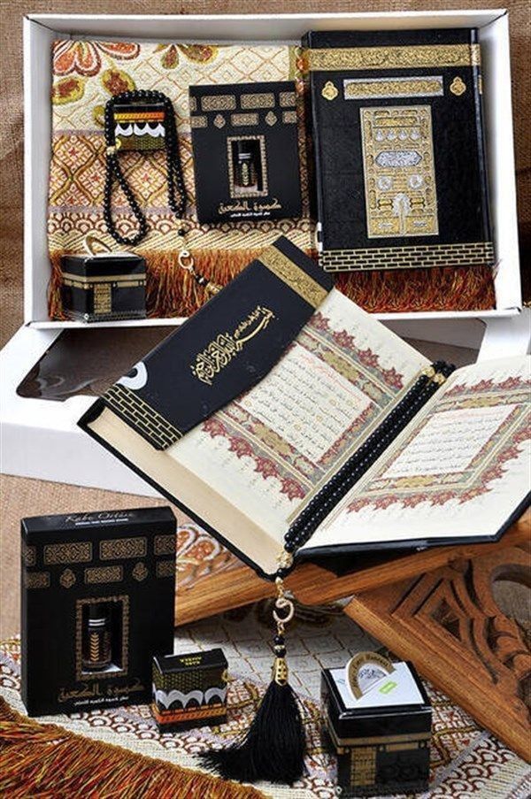 an open book sitting on top of a wooden table next to other books and accessories