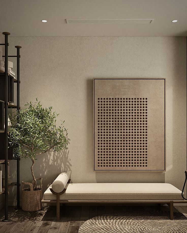 a living room with a couch, bookshelf and potted plant