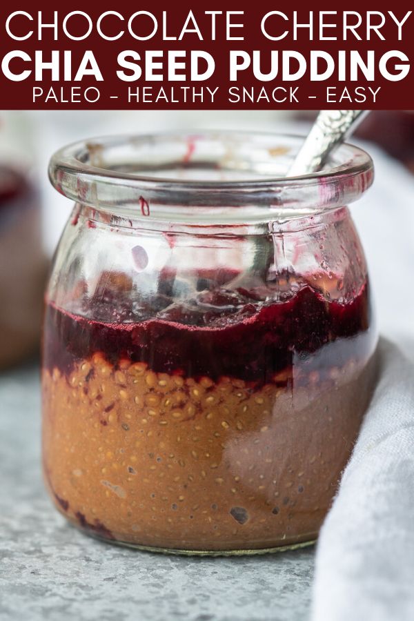 chocolate cherry chia seed pudding in a glass jar with a spoon on the side