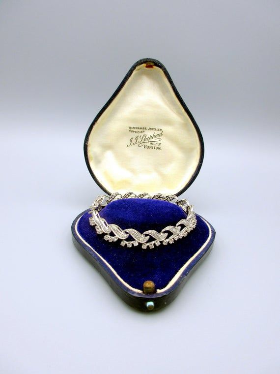 Gorgeous vintage Ladies 14k white gold and all diamond bracelet. It measures 7" long by 3/8" wide and looks delicate yet substantial at the same time. It has a locking bar safety clip and is marked 14k on the underneath of the clasp as shown. The antique boxes shown are for display purposes only and are not included in this listing. Luxury Vintage Bracelets With Diamond Hour Markers, Formal Hallmarked Diamond Bangle Bracelet, Silver Diamond Bracelet With Brilliant Cut For Evening, Evening Diamond Bracelet With Brilliant Cut, Silver Platinum Tennis Bracelet For Wedding, Silver Cubic Zirconia Diamond Bracelet For Evening, Wedding Silver Platinum Tennis Bracelet, Wedding Platinum Silver Tennis Bracelet, Vintage Platinum Bracelets With Diamond Accents