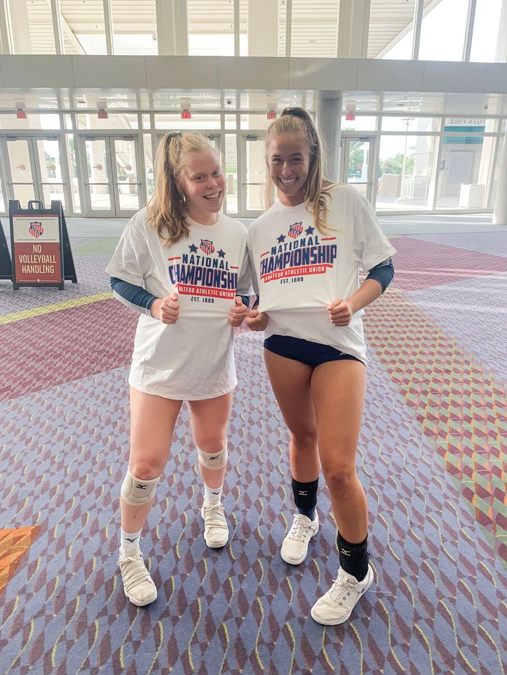 two young women standing next to each other in shorts and t - shirts with the words, michigan on them