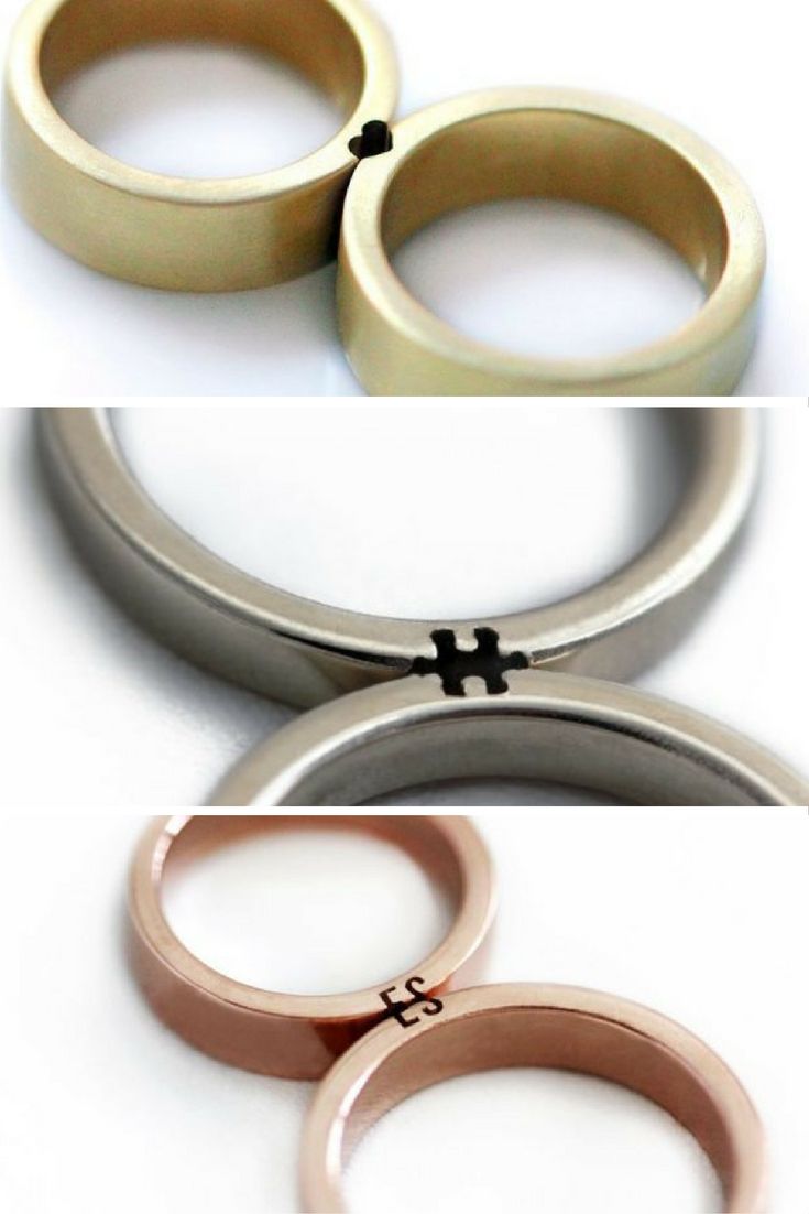 three different types of wedding rings with black crosses on the middle and white, gold, and silver bands