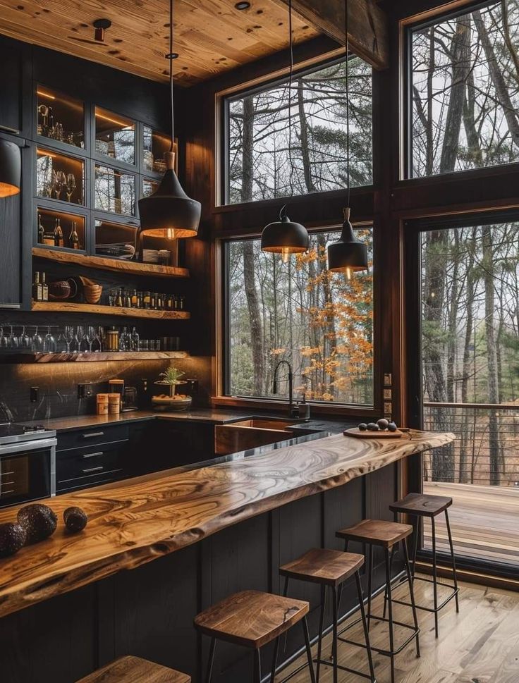 a kitchen with lots of counter space and wooden shelves on the wall, along with stools