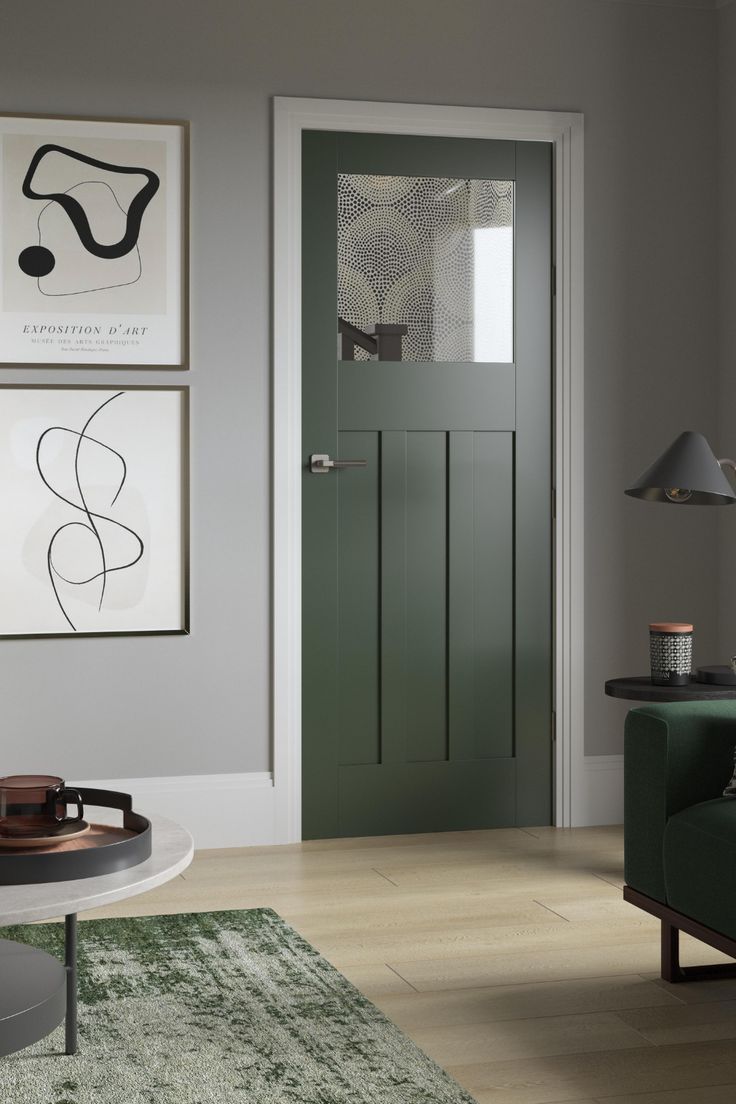 a living room filled with furniture and pictures on the wall next to a green door