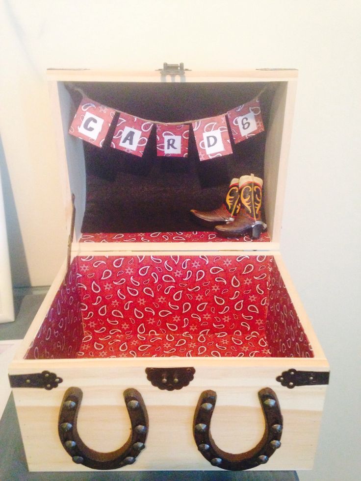 an open trunk with two horseshoes on the handle and some decorations hanging from it