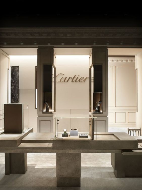 the interior of a cartier store with glass display cases and marble counter tops in front of it