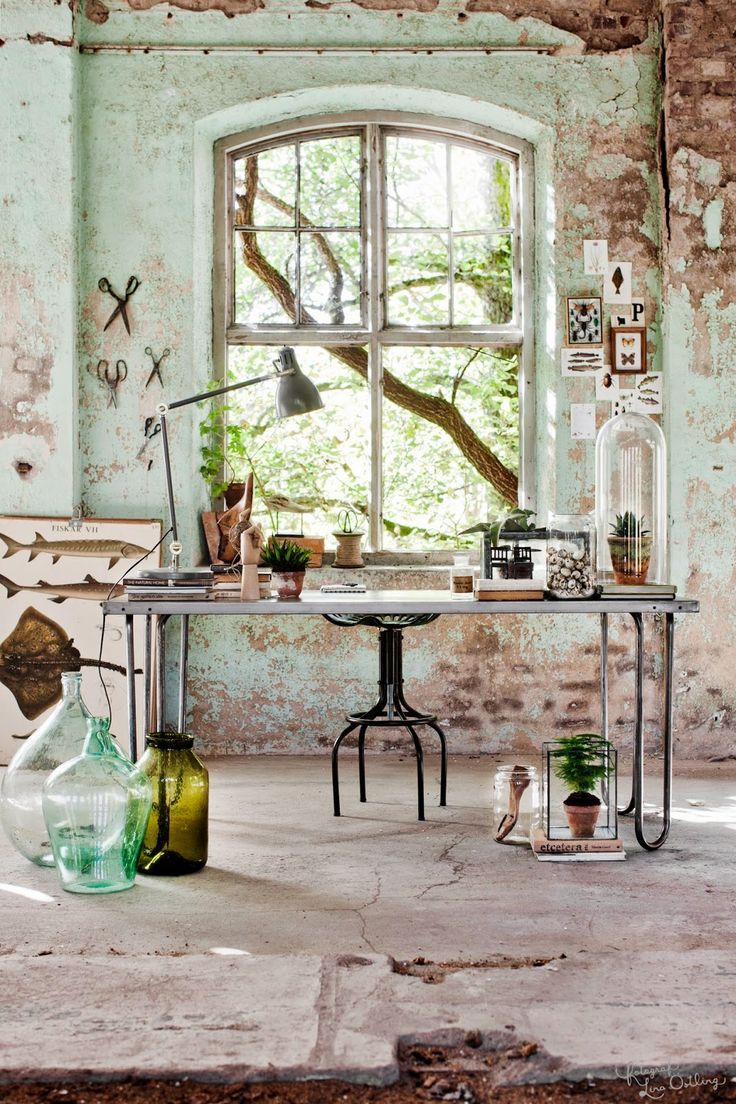 an old room with a table and vases