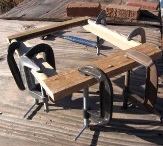 two wooden benches sitting on top of a wooden floor next to some metal work tools