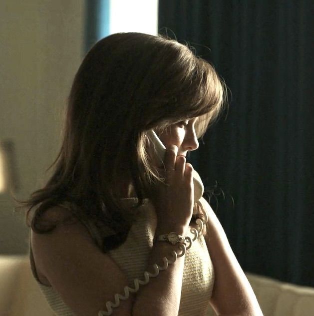 a woman talking on a cell phone in a living room