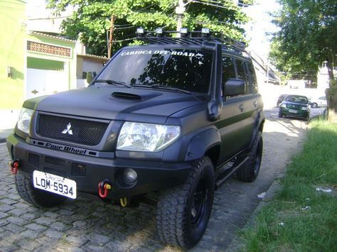 a black suv parked on the side of a road