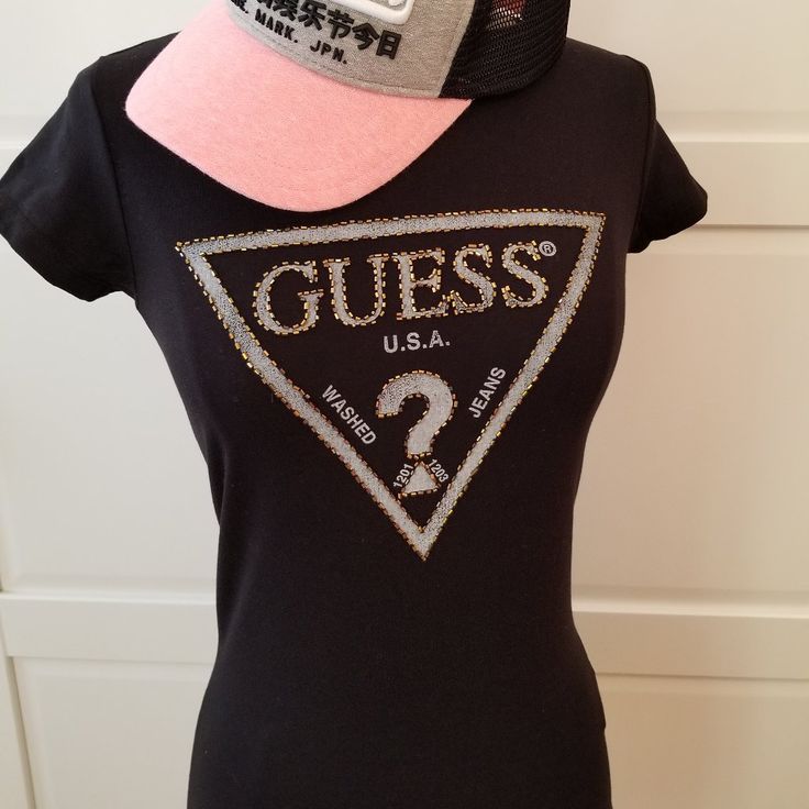 Brand: Guess Size: Xs Color: Black Shimmering Beads Adorn Our Iconic Logo In This Need-Now Knit Tee. Super-Stretch Knit Tee. Rounded Neckline. Short Sleeves. Beaded Triangle Logo At Front Made Of Cotton And Spandex Hand Wash **Only Guess Tee For Sale, Hat Is Not Included In The Listing** Fitted Black T-shirt With Rhinestones, Casual Black Sequined T-shirt, Trendy Embellished Black Tops, Trendy Black Embellished Tops, Fitted Casual Top With Rhinestones, Fitted Casual Tops With Rhinestones, Casual Fitted Tops With Rhinestones, Fitted Black Embellished T-shirt, Casual Rhinestone Tops For Night Out