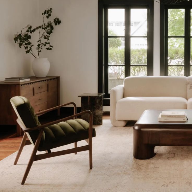 a living room with two couches and a coffee table in front of large windows