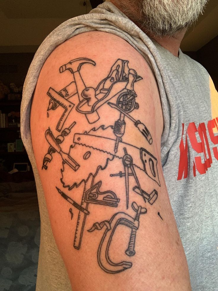 a man with a tattoo on his arm that has tools and wrenches all over it