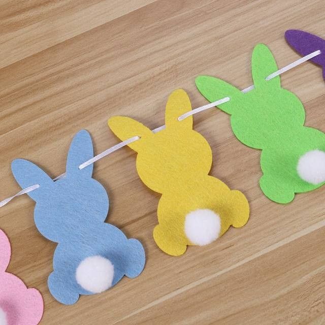 four felt bunny bunnies hanging on a clothes line with toothpicks in the shape of rabbits