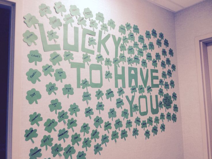 a wall with green shamrocks on it that says lucky to have you