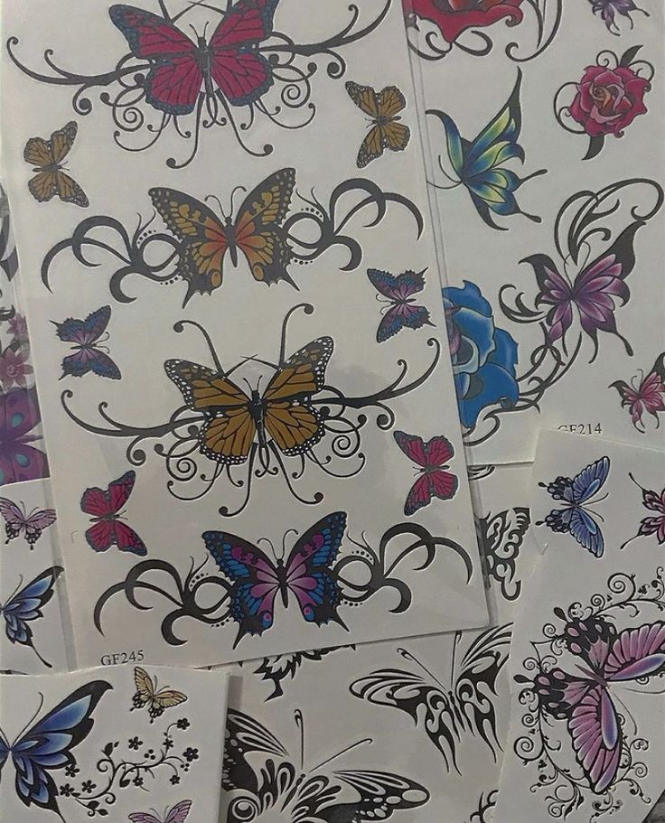 many different colored butterflies on white paper