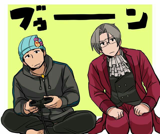 two people sitting on the ground with one holding a game controller in front of them