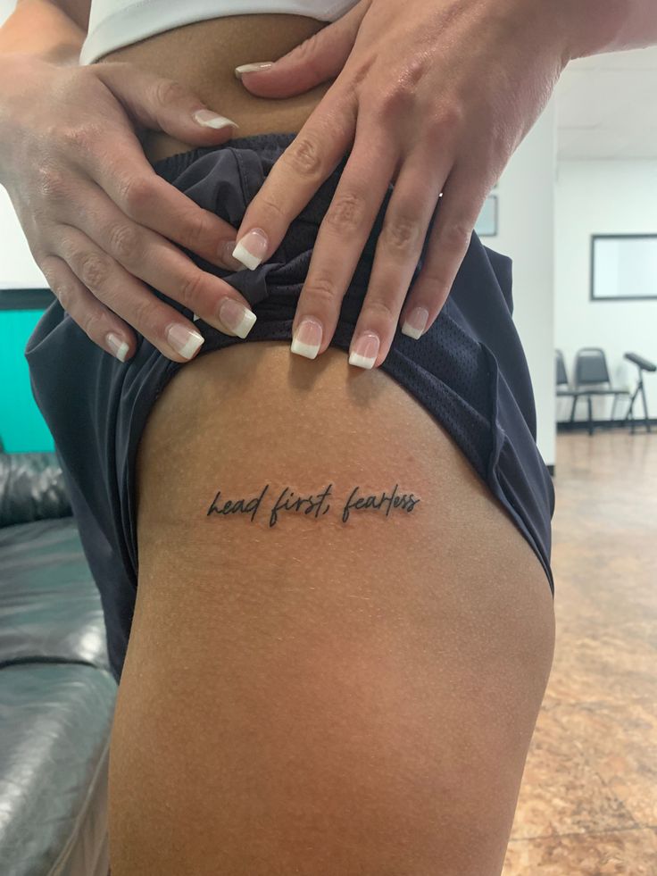 a woman's thigh with the words heard your feelings tattooed on her lower back