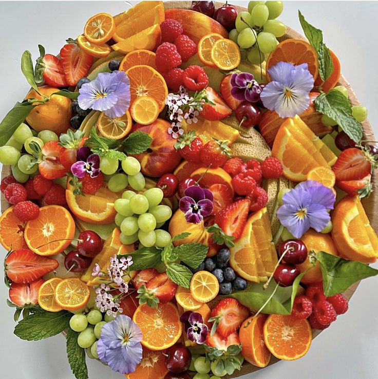 a platter filled with lots of different types of fruit