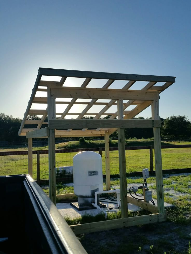 an outdoor water heater in the middle of a field