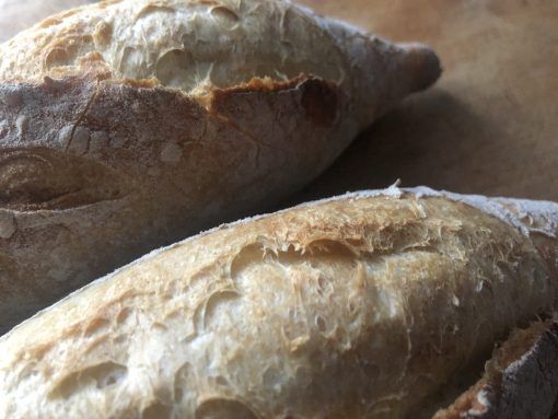 two loaves of bread sitting on top of a table