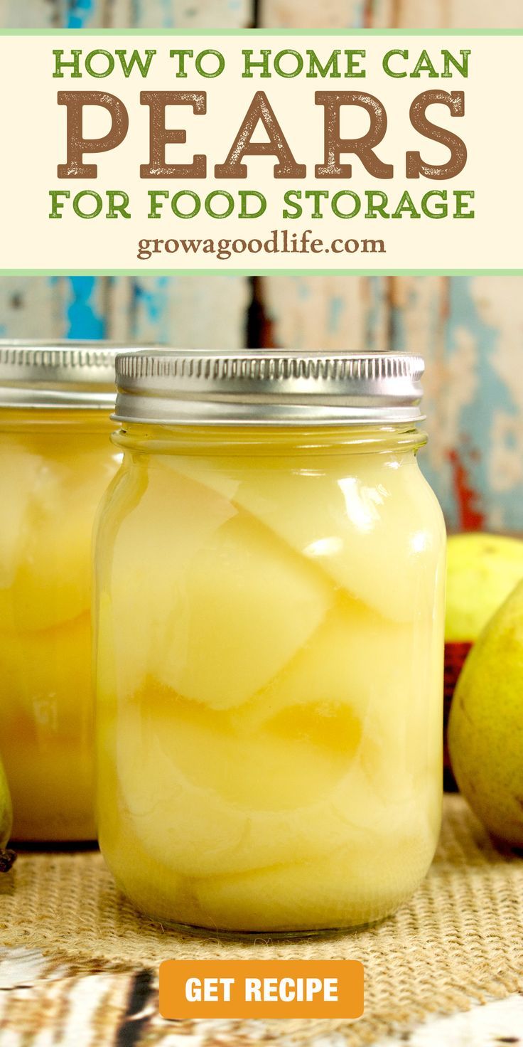 two jars filled with food sitting on top of a table next to apples and pears