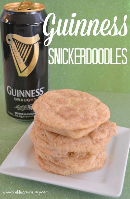 a stack of cookies sitting on top of a white plate next to a can of guinness