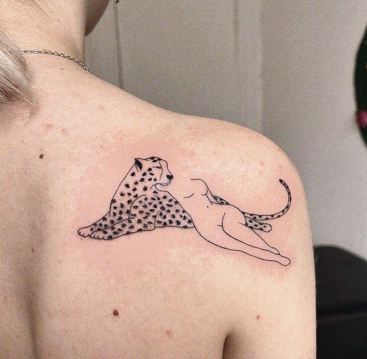 a woman with a cheetah tattoo on her upper back shoulder and the lower arm