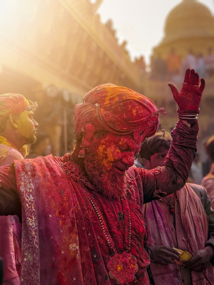 people dressed in red and yellow are celebrating holi day with colored powder on their faces