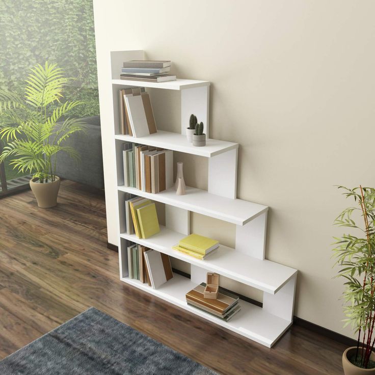 a white book shelf sitting on top of a hard wood floor