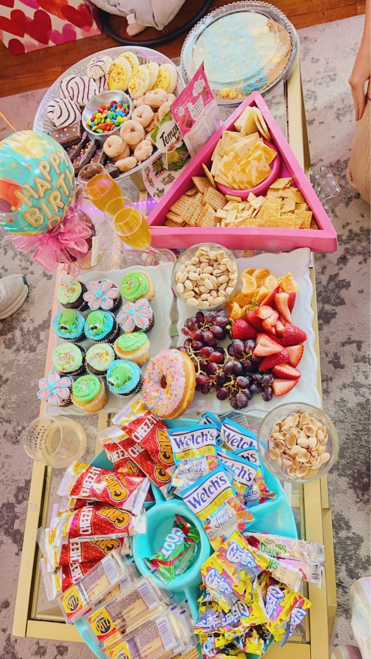 a table filled with lots of snacks and desserts