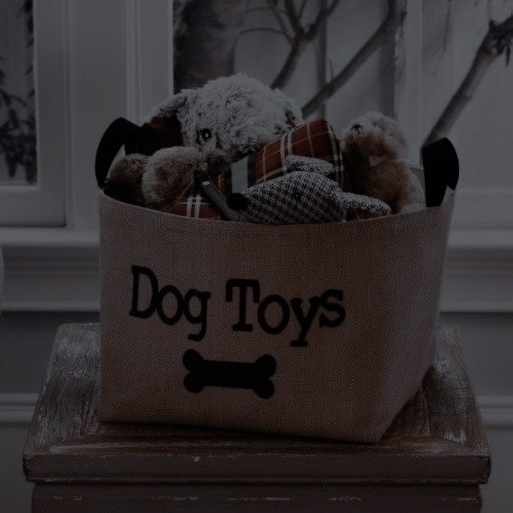 a dog toy basket with stuffed animals in it and the words dog toys written on it