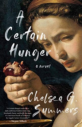 a woman holding an apple in her right hand and looking down at the book cover