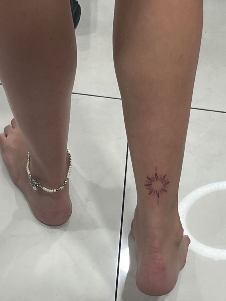 a woman's foot with a small tattoo on the side of her left leg