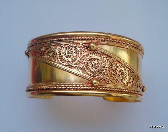 vintage antique gold vermeil gold gilded bangle bracelet cuff from rajasthan india. great handmade design good for jewelry collection.Inner circumeference - 15.5 cm (6.1")width - 3.2 cm (1.26") weight - 41 gramsmaterial - germen silver (metal) with gold plate. Antique Yellow Gold Cuff Bracelet For Ceremonial Occasions, Ceremonial Antique Yellow Gold Cuff Bracelet, Antique Gold Bracelet With Antique Finish, Gold Bohemian Bangle For Festivals, Vintage Yellow Gold Cuff Bracelet For Ceremonial Occasions, Bohemian Gold Bangle For Festivals, Ceremonial Gold Brass Cuff Bracelet, Gold Antique Finish Bangle For Gift, Gold Bangle With Antique Finish As Gift