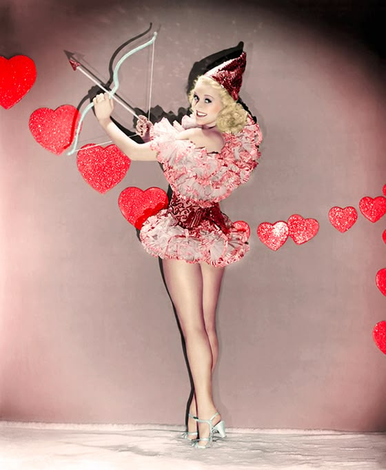 a woman in a red dress holding a bow and arrow with hearts flying around her